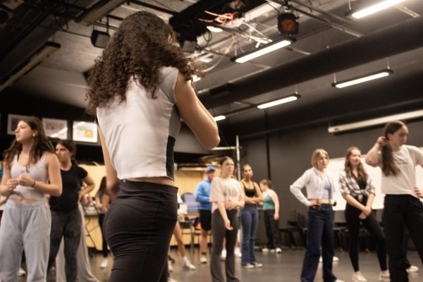 On the Dance Floor: Ilana Lieberman, North senior, looks upon her fellow featured dancers as they rigorously rehearse their challenging choreography. As featured dancers, they are required to difficult choreography to compliment the lead actors. 