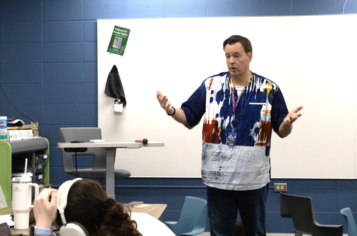 CLASSROOM CONNECTIONS: Matthew Whipple, Social Studies Teacher and Director of the Academy, engages in a conversation with his senior Academy students. After AP testing, the group shared laughs and reflections in one of their final moments together.