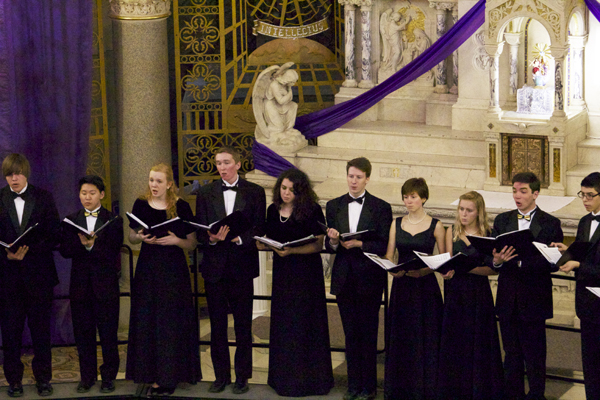 CHARMING CHAMBERS: Dressed in formal attire, South Chambers members sing with their music before them. Joined by members of the GBN choirs, the group performed at the heart of the chapel at Techny Towers. 