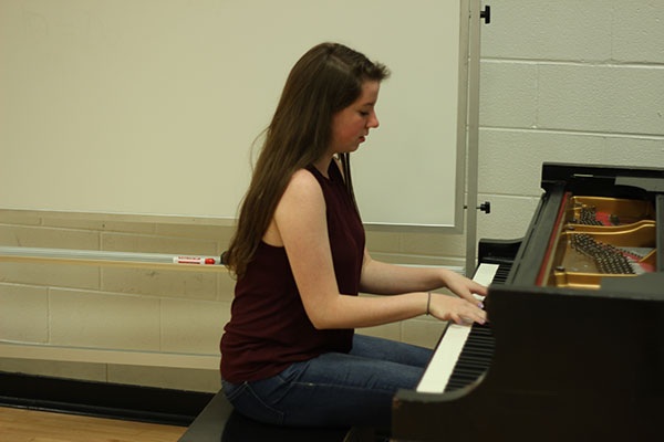 Concentrating on the keyboard, Claire Demorest plays the piano in Souths choir room. Demorest is involved in many of Souths choirs and musical productions.