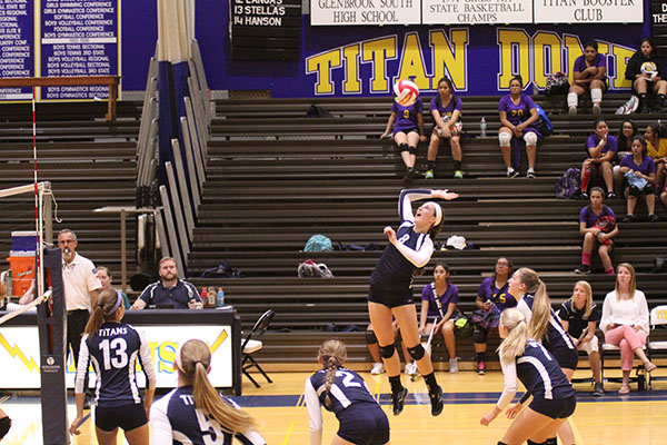 BUMP, SET, SPIKE: Jumping into mid-air, junior Zimmie Frerichs sets up to spike a ball against Waukegan on Sept. 16. The Titans won with a final score of 25-6 and 25-12.  
