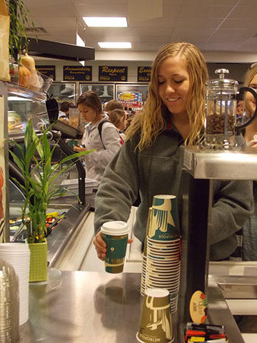 Caffeine Before Class: Fueling up for her day ahead junior Kati Ivanovich grabs a quick coffee before class, one of many hot beverages served daily in South's coffee station in the cafeteria.  