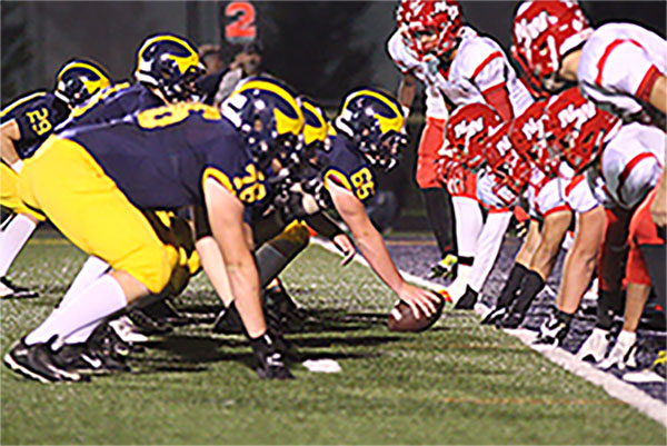 

LOCKED AND LOADED: Preparing to snap the ball, center Daniel Moses and the rest of the offenseive linemen ready themselves for an offensive play against Niles West. The season finished with a record of 4-5, and the Titans were unable to make it to post-season. 