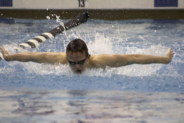 FLYING FORWARD: Looking towards the wall, senior Peter Dales takes a quick breath during his 100-yard butterfly against Niles West on Jan. 22. Dales swam the 100-yard butterfly in 59.77 seconds, coming in second place behind Niles West’s Adam Orynczak.