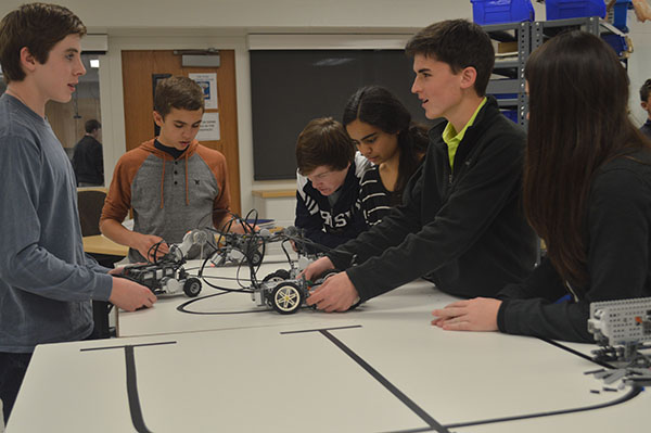 BRIGHT BUILDING: Piecing together the finishing touches for their vex robots, sophomore Science, Technology, Engineering and Mathematics (STEM) students (from left to right) Colb Uhlemann, Andrew Waldherr, Brian O’Connor, Savera Zulfqar, Jarrett Prchal and Abby Grant work together to finish their projects. The students utilized their team building skills, building technique, and coding to assemble the robots.