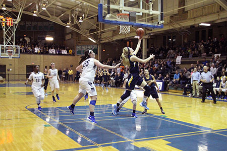 DON’T MESS WITH MORRISON: Running past two Trinity defenders, Senior Captain Caitlin Morrison shoots a left-handed layup, scoring two points for the Titans on Feb.  20. The women lost with a total score of 39-23, but overall had a memorable season, according to Head Coach Steve Weissenstein. 