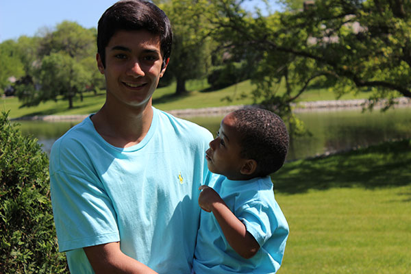 FOSTERING FAMILY: Posing for a photo with his foster brother, senior James Catizone spends quality time with three-year-old AJ. Catizone and his family fostered AJ for five months during his sophomore year at South through a program called Safe Families. The program works to offer children temporary homes for a duration of time in which their parents are unable to care for them. Photos courtesy of James Catizone