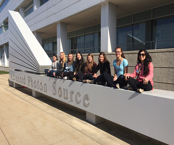 Women at Work: Six juniors along with science teachers Jill Serling and Lisa Pavic sit outside the Advanced Photon Source building of the Argon National Laborarory on April 14. The women attended a conference that encourages women to get involved in STEM fields and gives aspiring scientists a look into the real world of science. 