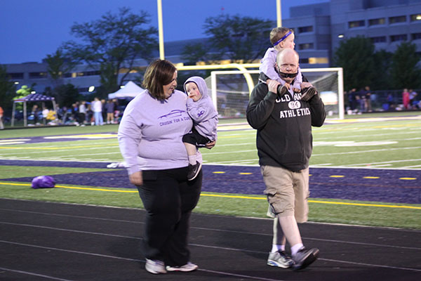 STRIDES FOR A CURE: Dedicated to the cause, a few participants walk purposefully around the South track at the annual Relay for Life event.  The goal of the night is to raise money for a cure to cancer. 