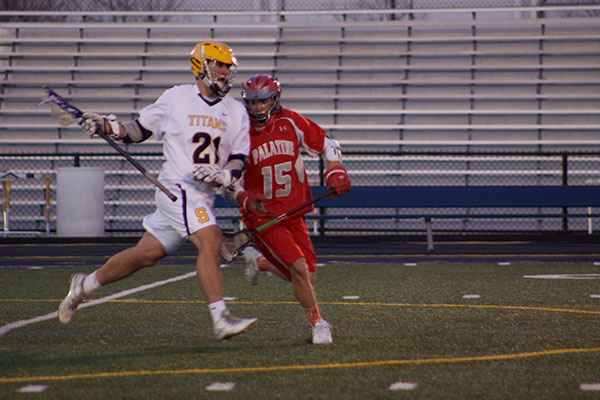 LOOK TO SHOOT: Cradling down the field, senior captain McLain Murphy dodges past the Palatine defense. The men played Palatine on April 4, and ended with a score of 15-2.  