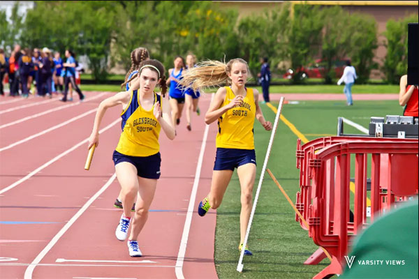 RUNNIN’ ROSE: After grabbing the baton from her teammate, senior Rose O’Grady runs in the Niles West Sectional meet on May 12. The Titans sent four girls to participate in the IHSA state meet this season.  Photo courtesy of Varsity Views