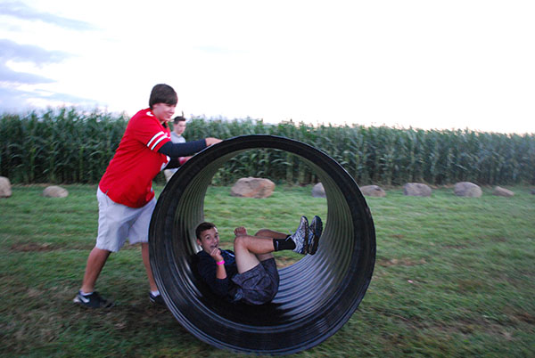 LET THE GOOD TIMES ROLL: Being pushed by junior Sam Dale, junior Michael Heftman enjoys an attraction at the Richardson Corn Maze. This activity was an option available to students who attended this Students For Students event on Sept. 10.