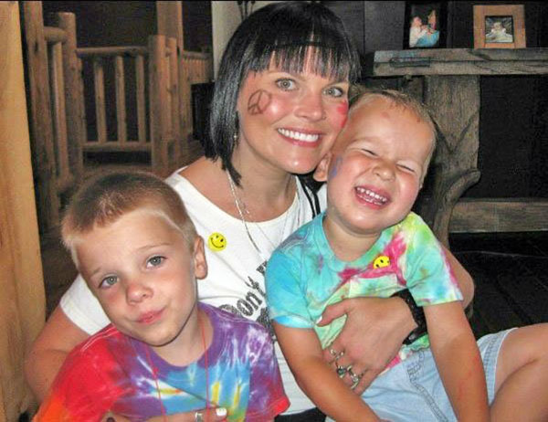 HAPPY   HIPPIES: Decked out in costume attire, Paula Hess, Titan Poms coach, poses with her sons Otto (left) and Nelson (right) for a themed family reunion. She was beloved by both family and friends, having a positive impact on their lives. Photo courtesy of Julie Smith