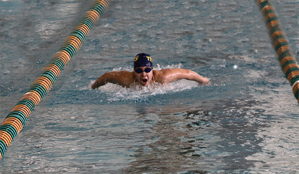 Soaring,  Flying: Looking towards the wall, senior Allison Wyland takes a breath as she swims her 100-yard butterfly at the Spartan Sprint Classic Invite on Sept. 17. The Titans placed 4th in the invite; they also beat GBN in a dual meet on Sept. 16 by a score of 104-82. 