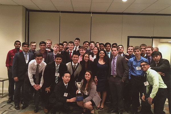 Titans with trophies:  After a victory, South’s former 2015-2016 BPA team poses at the BPA State Competition held in Oakbrook, Illinois during March of 2016. The trophy, referred to as the Professional Cup, was won by South’s BPA team for being the most outstanding BPA chapter in Illinois. Photo courtesy of Rosie McManamon