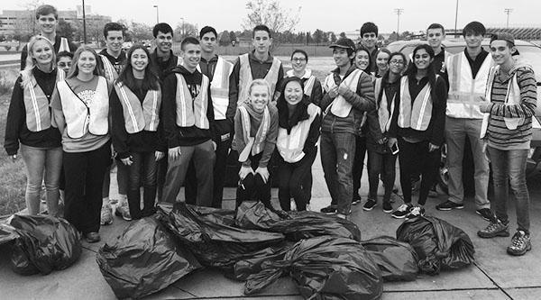 CLEANUP CREW: Posing with bags of trash, Interact members proudly display their success in cleaning a portion of Landwehr road. Interact and other clubs at South have planned several environmental awareness-based service projects. Photo courtesy of Lily Sands
