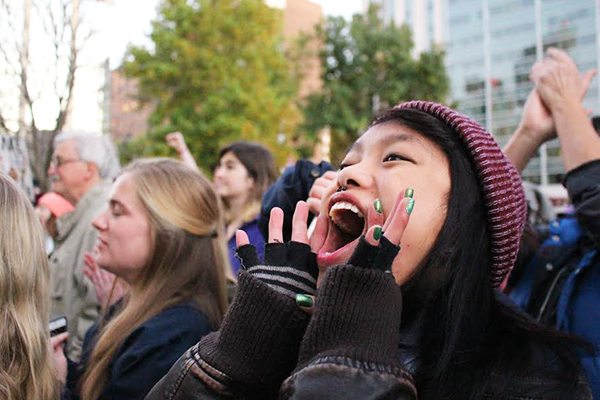 Passionate Protester: Yelling to show support, a young woman takes part in a protest against hateful rhetoric and ideals in Indianapolis, Indiana. The demonstration, held on Nov. 12, started at the Statehouse before protesters began to march downtown.