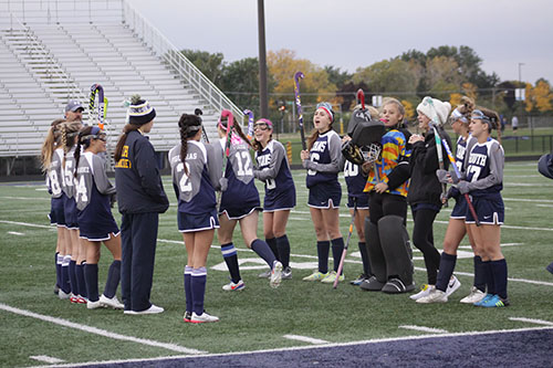 SISTER SUPPORT: Preparing for a game, the womens field hockey team draws on each other for support. Womens field hockey is just one sport that utilizes the big and little sister program at South. 