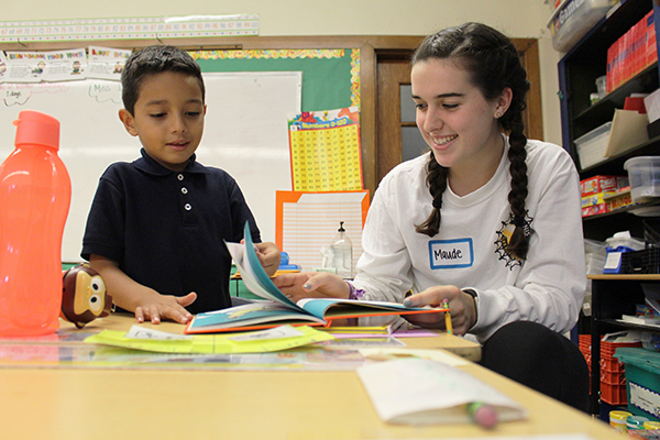 SERVICE OVER SELF: Working with a student from Passages Charter School in Chicago, senior Maude Tarbox engages in one of Key Clubís Eat ‘N’ Read events on Sept. 23. The club promotes various service opportunities within local and global communities.