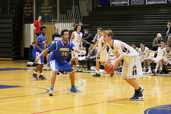 Head   in   the   Game:  Dribbling down the court, sophomore Gavin Morse looks past a Prosser player as he makes his way towards the net. The Titans went on to win the game 57-44.  