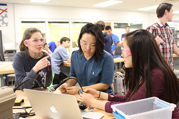 GIRL GENIUSES: Discussing and planning, sophomore Sophie Nathanson, senior Elizabeth Park and junior Katheryn Woo develop a prosthetic hand. The prosthetic hand that Society of Women Engineers designed and created was donated to e-NABLE, an organization that sends prosthetics to those in need.