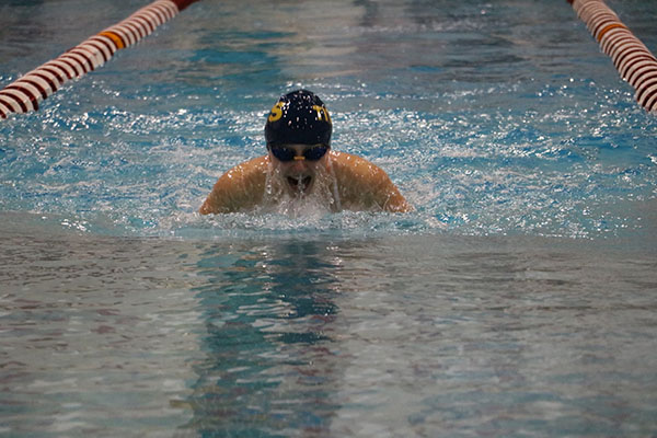 RULE THE POOL: Lunging forward, senior Maddie McMillin swims the 100 yard breast stroke during the Niles West Dual Meet on Oct. 21.