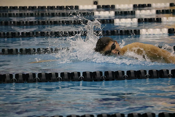 MAKING  A   SPLASH:  Quickly breathing, senior swimmer Sam Iida  races the clock in the 200 yard freestyle where he broke the pool record with a time of 1:39.97.