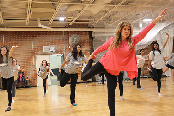 BALANCING ACT: Dance teacher Trisha Moulakelis demonstrates a yoga pose during Dance 1. She will be teaching Dance 2, a new class that is available to take next year.