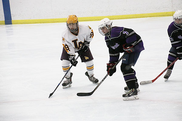 icy hot: Preparing to receive a pass from a teammate, GBS sophomore Shannon Schmitt looks to make a break away and score against Loyola during a game on Jan. 29 at the Northbrook Ice Arena. The team went on to play two more games against Loyola. 