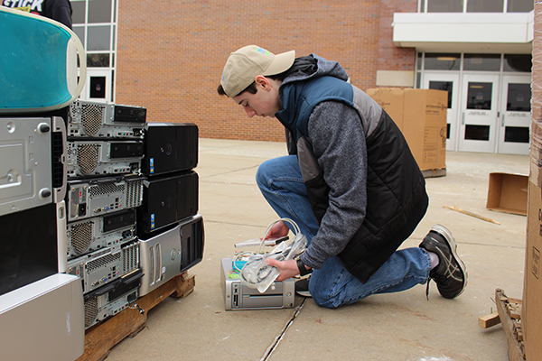 Counting Computers:  Inspecting a computer, Interact senior leader Justin Bifeld examines the donations for the Interact Computer Drive on Jan. 14. Interact leaders noted an increase in this yearís donations in comparison to previous years.