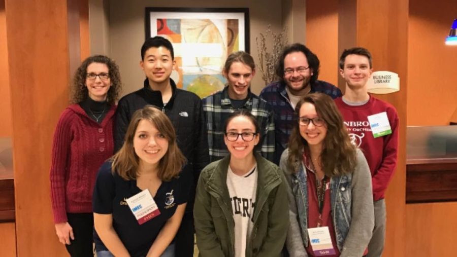 Performers in Peoria: Kristin Meyer and Aaron Kaplan, GSO co-conductors, pose for a picture with ILMEA state finalists Ellis Cho, Jack Sundstrom, Jack Kelly (top), Kayleigh Markulis, Andrea Radaios and Emma Brooks (bottom) at the ILMEA state festival. The festival took place from Jan. 26-28 in Peoria.