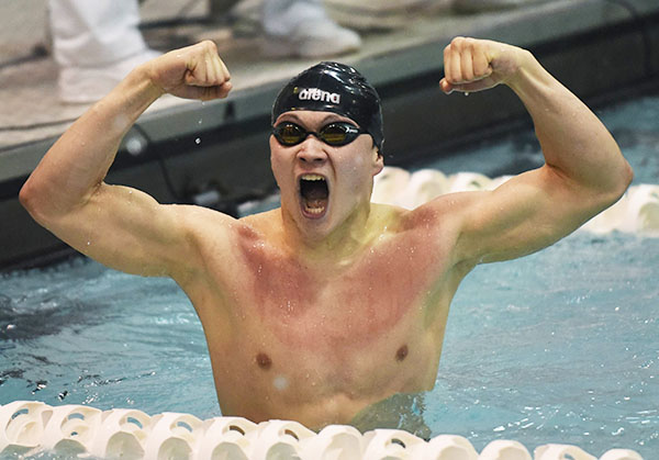 Reacting to his win, Senior Sam Iida celebrates a State record-breaking time of 1:46:02 in the 200 yard Individual Medley at the IHSA State Finals meet. Iida also placed first in the 500 yard freestyle with a time of 5:23.63. 