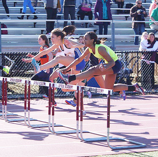 HURDLE HERO:  Jumping over a hurdle, Junior Bailey Smith, competed in the IHSA Sectionals at Loyola Academy on May 11. Smith competed in State last weekend and placed 20th in the 100 meter hurdle with a time of 17.47.