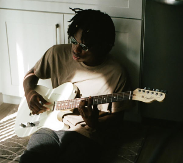 SOULFUL CAESAR:  Playing his guitar, Canadian artist Daniel Caesar practices songs from his most recent album, Freudian, released August 2017, pictured above. His honest and personal music is influenced by throwback R&B and classic gospel.