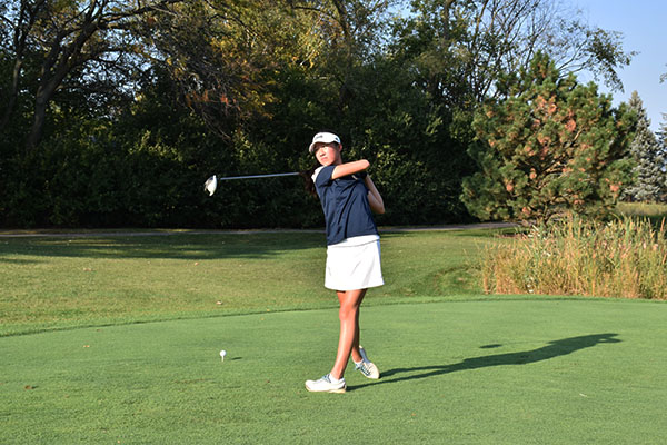 Taking a practice shot, senior Sophia Lau finishes her swing with a follow through. Lau competed with the rest of her team at state on Oct. 13 and 14.