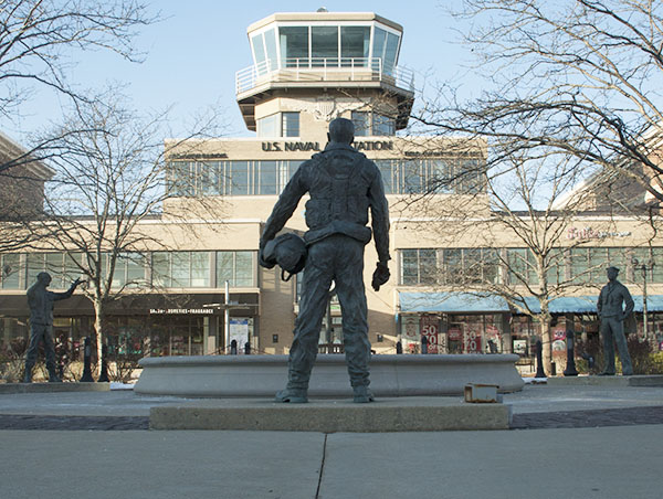 Standing in front of the retired Naval Air Station, a statue overlooks retail shopping stores that replaced the previous building. A memorial commemorating the men and women that served at the station now stands across the street in the Glen Town Center. 