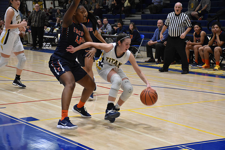 HEAD IN THE GAME:  Driving past an Evanston defender, senior Lizzy Shaw dribbles on the Titans home court. The Titans fell to the Evanston Wildkits 54--31. 