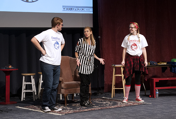 PUNNY PALS:   Performing under the spotlight, juniors Jack Taylor and Ellie Eavenson improvise their act during the Comedy Sportz show, alongside Leader Beth Ann Barber. Two teams compete for points in Comedy Sportz competitions and audience participation is always incorporated. 