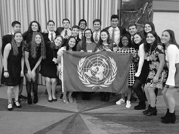 DISTINCT DELEGATES:  The GBS Model United Nations Team poses at the National High School Model United Nations Conference (NHSMUN) in New York City (left). After the team was honored with an Award of Distinction, Katie Roberts, co-president of Model UN, and senior Tricia Katsamakis smile at the camera (right). The Award of Distinction is the highest honor a team can earn at NHSMUN and was only awarded to three schools across the country. Photos courtesy of Leah Dunne 