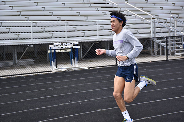 Senior Jordan Theriault finishes his first lap of practice. Track’s next meet is the Glenbrook South Quad on     	     April 24 at home. The men’s track team recently placed 4th at indoor conference. 