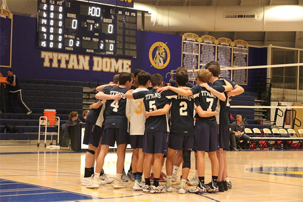 DREAM TEAM: Huddling during a game, the Men’s volleyball team discusses the next play. The Titans finished 17-15 and 6-4 in conference.
