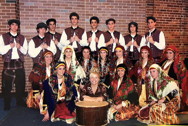 REMEMBERING THE RETIREES: Posing with her dance members for South’s 2006 Variety Show, Cindy Pouplikollas (bottom row, second from the left) participates in the Teacher’s Act Tradition; Pouplikollas is now retiring after 23 years as P.E. administrative assistant. 