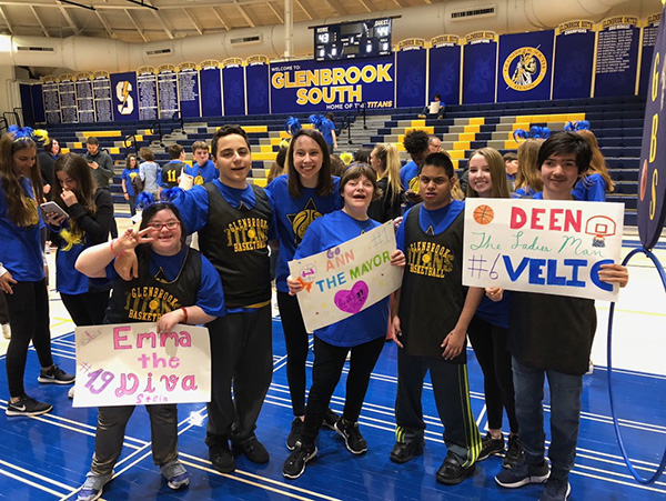 ALL-STAR ALI: Standing with friends, late senior Ali Merchant (third from right) and senior Leza Bergin (third from left) take a photo after the TLS basketball game. Along with the basketball game, Merchant participated in many activities throughout his time at South. Photo courtesy of Leza Bergin