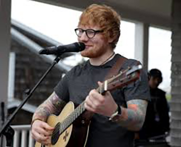 Jolly Ginger:   Sheeran performs onstage in Chicago on Oct.4 at Soldier Field. www.billboard.com