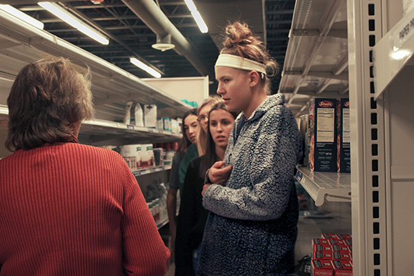 South    Souperheroes: Visiting the Northfield Food Pantry, senior Kate Gregory, student body president, listens to a pantry representative to gauge their food supply levels. The Northfield Food Pantry serves 700 families. 