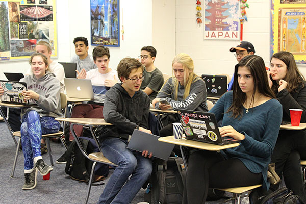 History Hangout: Playing a Kahoot after a presentation on history, seniors Yvonne Fondrevay (left), Samuel Polyakov (center) and Maja Markovic (right) wait for the next question to appear. History Club plays Kahoots after presentations and participates in quiz bowls once a month. 