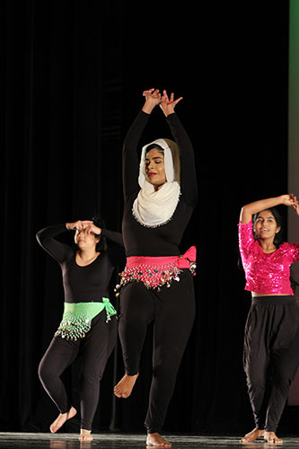 Shakin Shareef:   Moving in time to the music, senior Zainab Shareef dances onstage amongst her orchisisters. The 2018 Dance Show “Captivate” was on Friday, Dec. 7. 