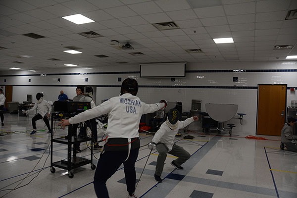 Attempting to get a touch, senior Maxwell McWilliams practices his fencing skills.