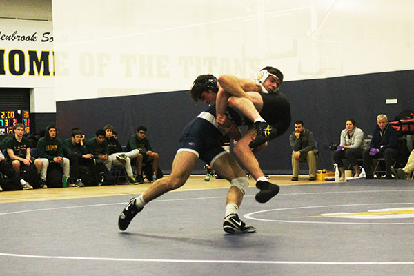 
Carryin   Crecan:   Taking down a Fremd wrestler, junior Norbert Crecan attempts to gain a win for the South varsity wrestling team. The Titans won the match against the Fremd Vikings 37--36. Photo by Dany Herrera 