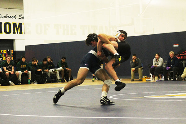 
Carryin'   Crecan:   Taking down a Fremd wrestler, junior Norbert Crecan attempts to gain a win for the South varsity wrestling team. The Titans won the match against the Fremd Vikings 37--36. Photo by Dany Herrera 